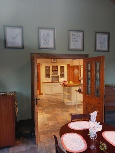 a kitchen with two tables and a dining room at Tullynacrunat Lodge in Castleblayney