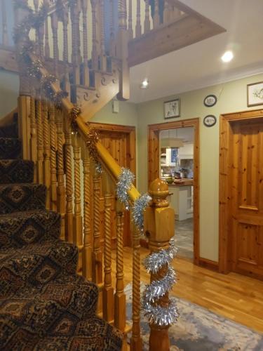 a staircase in a house with christmas decorations at Tullynacrunat Lodge in Castleblayney