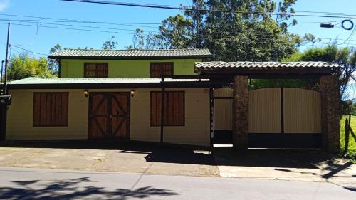 a house with a gate and a garage at Cabañas Tierra Fertil in Montaña