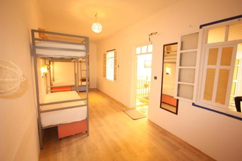 a room with two bunk beds and a hallway at El Boussouni Hostel in Marrakech