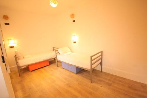 a hospital room with a bed and a chair at El Boussouni Hostel in Marrakech