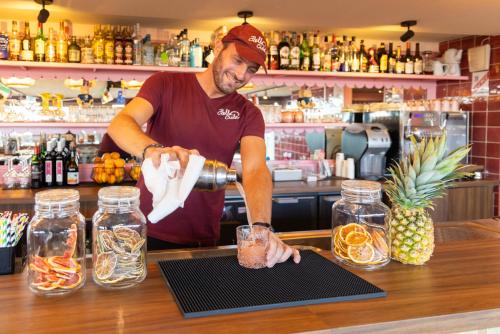 a man preparing a drink at a bar at Mercure Nice Centre Notre Dame in Nice
