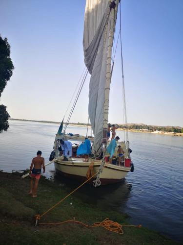 a group of people on a sail boat in the water at Aswan Felucca sailing boat and Hotel in Aswan