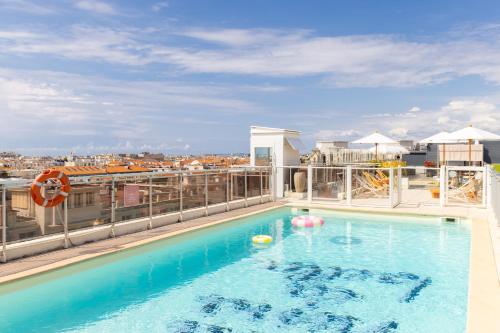 a swimming pool on the roof of a building at Mercure Nice Centre Notre Dame in Nice