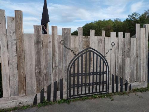 a wooden fence with a gate in front of it at Cabane Terrasse et potager in Rambouillet