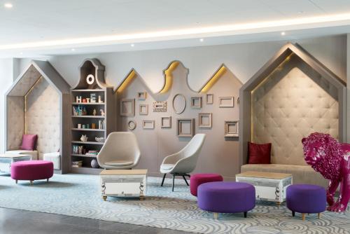 a living room with a couch and chairs at Mercure Gdańsk Posejdon in Gdańsk