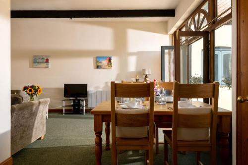 a dining room with a table and two chairs at The Granary in Tunstead
