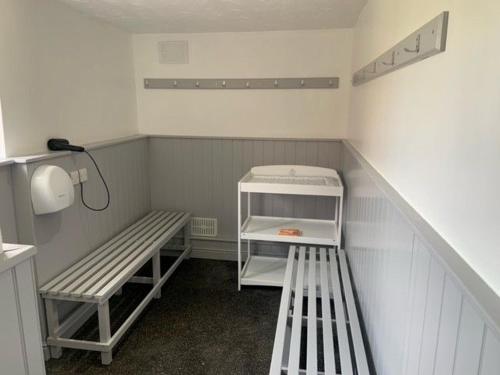 a small room with two benches and a shelf at The Granary in Tunstead