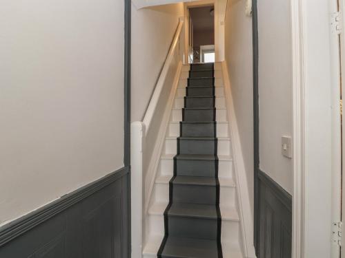 a staircase in a house with black and white at Badgers in Sedbergh