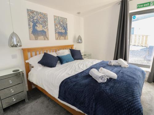 a bedroom with a bed with two towels on it at Osprey View Lodge & Hot Tub in Aberfeldy