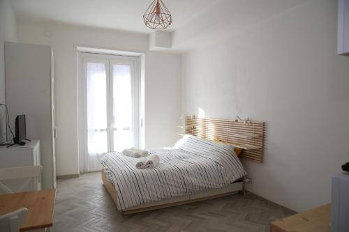 a bed in a white room with a window at Princess Apartment 2 - Turin - Like at Your Home in Turin