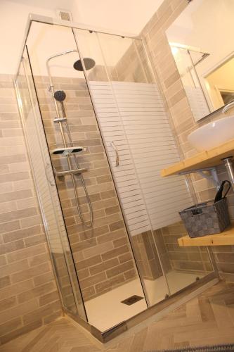 a glass shower in a bathroom with a sink at Princess Apartment 2 - Turin - Like at Your Home in Turin