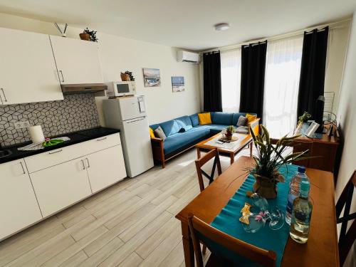 a kitchen and living room with a table and a couch at Apartamento perla marina in Morro del Jable