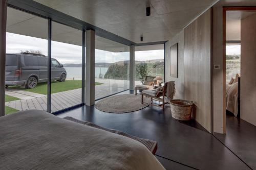 a bedroom with a view of a van parked outside at Edge House in Aberporth