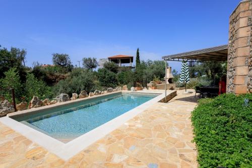a swimming pool in a yard with a house at SPITI-MANOLIS in Levktron