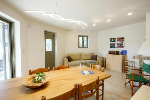 a dining room and living room with a wooden table at SPITI-MANOLIS in Levktron