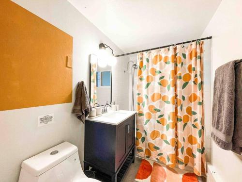 a bathroom with a sink and a toilet and a shower curtain at Mountain View Apartment / stylish / cozy / central in Colorado Springs