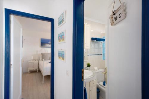 a bathroom with a mirror and a sink and a tub at Puerto Chico A in Playa Blanca