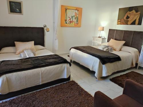 a bedroom with two beds and a couch at Lemos family beach house in Nazaré