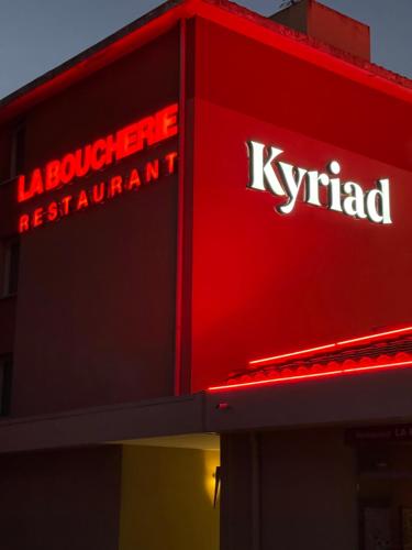 a sign on the side of a krispy kreme restaurant at Kyriad Aix Les Milles - Plan de Campagne in Bouc-Bel-Air