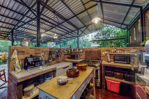 a large kitchen with many appliances in a building at Nueva Villa Paraíso Four Villas in Lagunillas