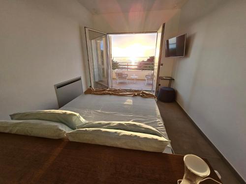 a bed in a room with a large window at Villa Dune Luxury Roof Top Pool Wellness in Gallipoli