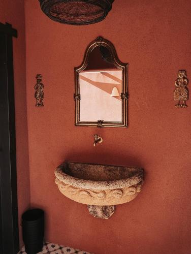 a bathroom with a stone sink and a mirror at La Cobija Apartamentos - Solo Adultos in Ciudad Real