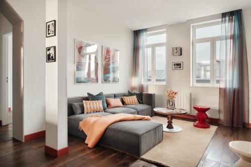 a living room with a couch and a table at Edgar Suites Lille - Faidherbe in Lille