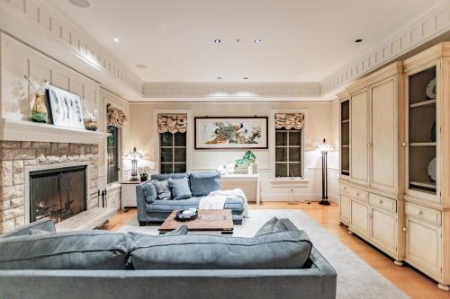 a living room with a couch and a fireplace at Vancouver Golf Villa - Private Oasis in Vancouver
