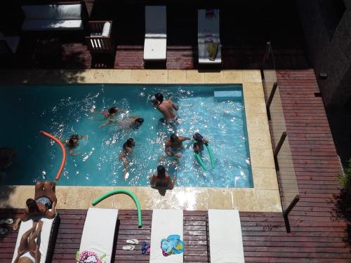a group of people swimming in a swimming pool at Posta Cangrejo Apart in Las Gaviotas