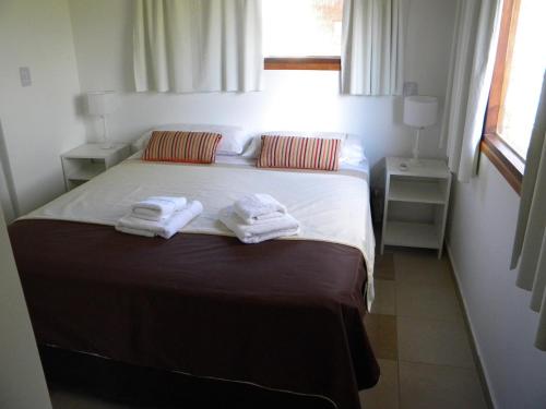 a bedroom with a bed with towels on it at Posta Cangrejo Apart in Las Gaviotas