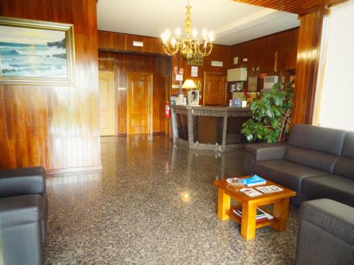 a living room with a couch and a table at Hotel Estalagem Turismo in Bragança