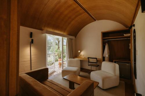 a living room with a couch and chairs and a window at La Posada del Puente in Arequipa