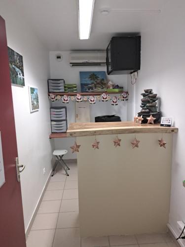 a kitchen with a counter with stars on it at HOTEL LE CHANNEL in Le Marin