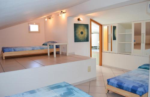 a living room with two beds and a table at Pozzo al Moro Village in Marina di Campo