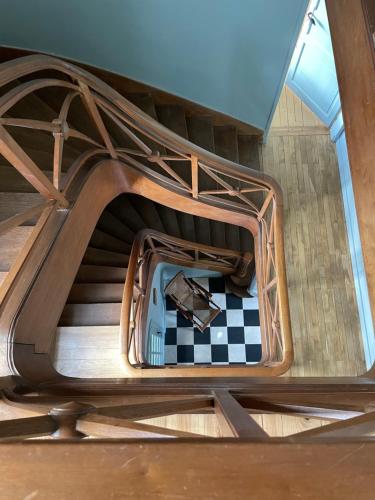 a spiral staircase with a car on a checkered floor at La Grimaudière in La Chapelle-sur-Erdre