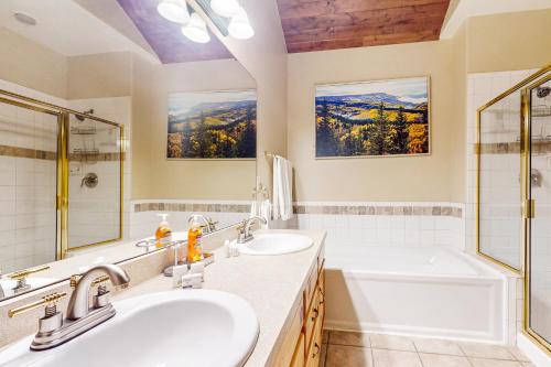 a bathroom with two sinks and a tub at Northstar Townhome Unit 1968 in Keystone