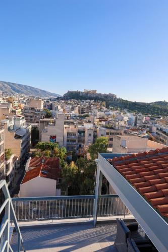 a view of a city from the balcony of a building at PANORAMIC SUITE in Athens