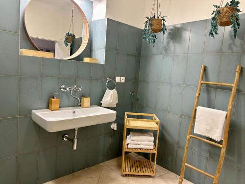 a bathroom with a sink and a mirror at Almond Studio Apartment in Bratislava