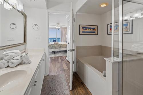 a white bathroom with a tub and a sink at Ashworth 1809 in Myrtle Beach