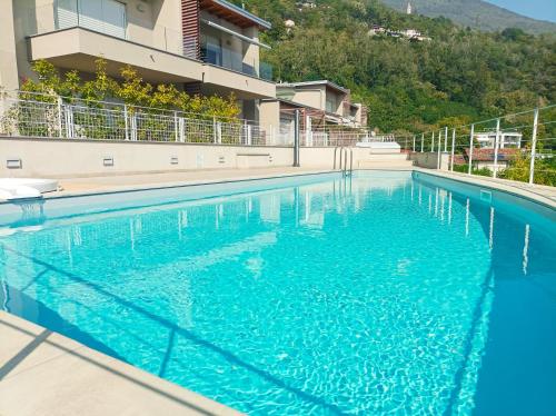 a blue swimming pool in front of a building at Vigna Panorama in Gera Lario