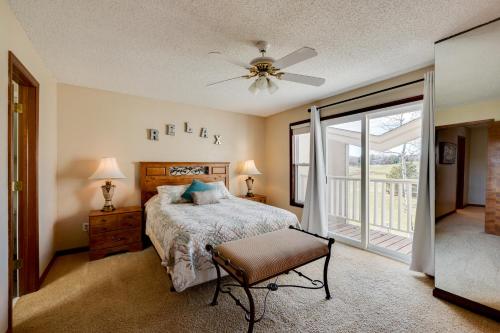a bedroom with a bed and a sliding glass door at Loveland Townhome Walkable to Lake and Park! in Loveland