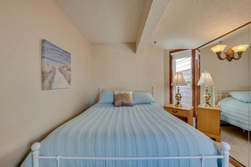 a bedroom with a blue bed and a mirror at Loveland Townhome Walkable to Lake and Park! in Loveland