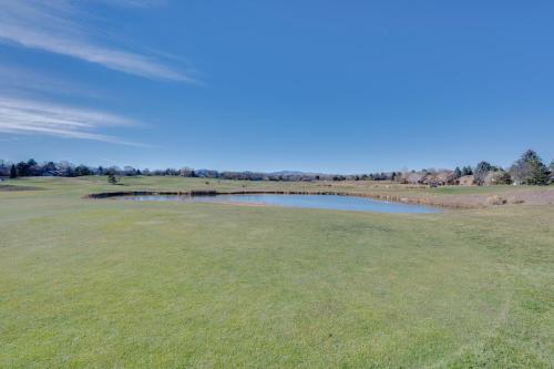 a golf course with a pond on a green at Loveland Townhome Walkable to Lake and Park! in Loveland