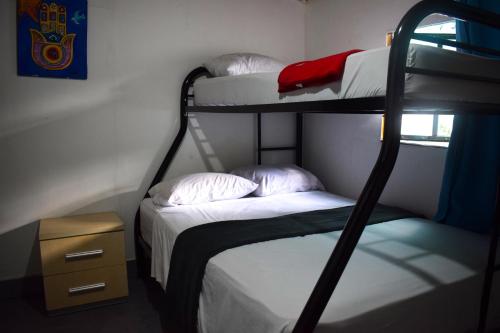 a room with two bunk beds and a table at Hostal Loco Coco Loco in Panama City