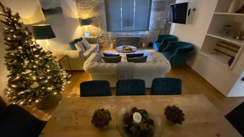 a living room with a christmas tree and a table at ROYAL WILLIAM YARD Luxury Apartments at "THE BRUCE" - FAMILY APARTMENT and Connecting DELUXE STUDIO - PRIVATE connecting lobby so BOOK BOTH For LARGER GROUPS - FREE ONSITE PARKING in Plymouth