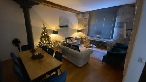 a living room with a christmas tree and a table at ROYAL WILLIAM YARD Luxury Apartments at "THE BRUCE" - FAMILY APARTMENT and Connecting DELUXE STUDIO - PRIVATE connecting lobby so BOOK BOTH For LARGER GROUPS - FREE ONSITE PARKING in Plymouth