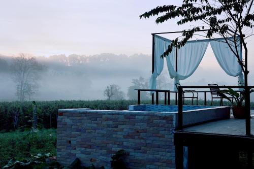 a bed with a canopy on top of a brick wall at WC Coffee&ไร่หวานซึ้ง in Mae Hong Son