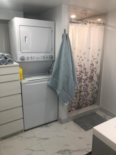 a kitchen with a washing machine and a shower at Home from Home! in Brampton