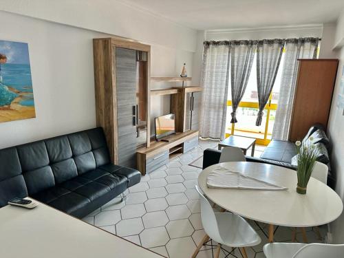 a living room with a couch and a table at Apartamento Atlantico - Vista Mar in Monte Gordo